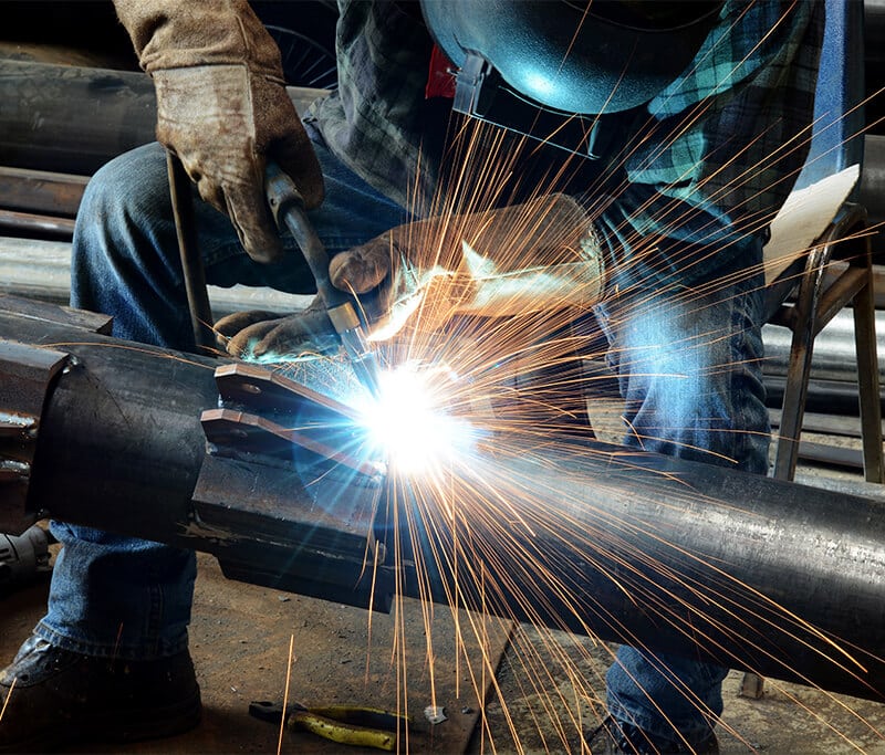 Man Welding Metal for Contact Staffing